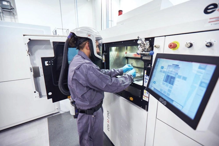 Additive Manufacturing Technician setting up a hybrid CNC-AM Machine to make a part for a aerospace manufacturer.