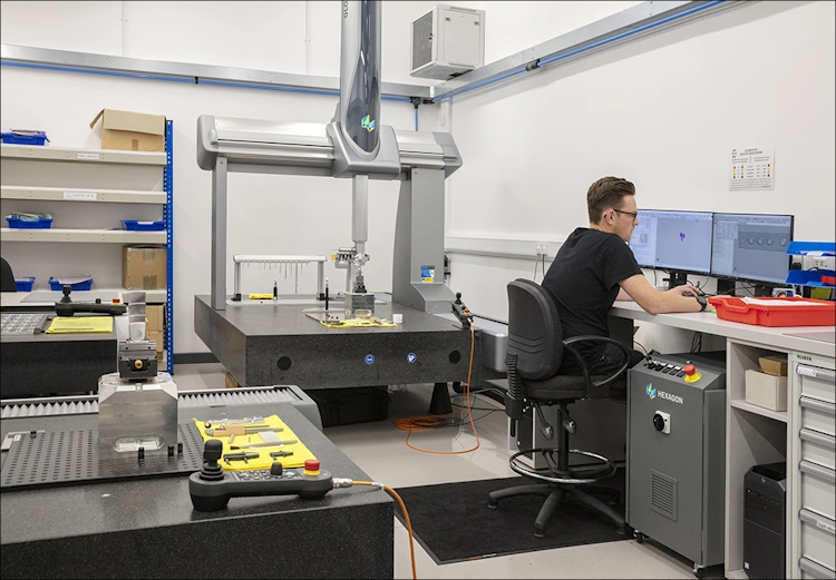 CMM Programmer using a Hexagon Coordinate Measuring Machine programming in PC-DMIS.