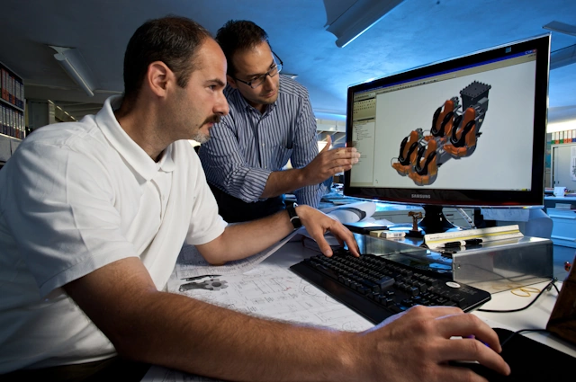 Mechanical Engineers using Solidworks to design an assembly for a roller coaster ride.
