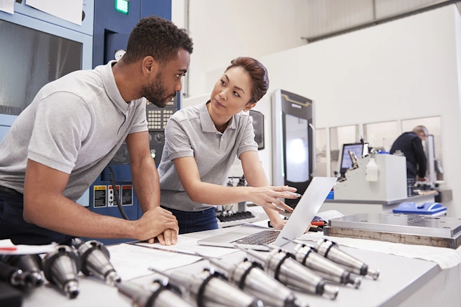 Two Machine Shop managers deciding which tooling to use for the next machining job.