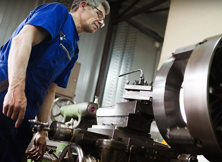 A manual machinist setting up a lathe.