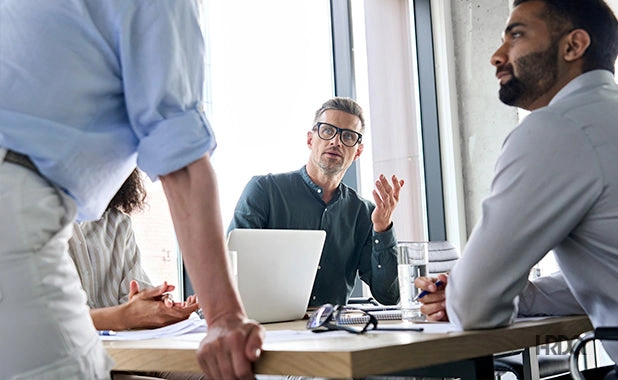 An urgent team meeting of recruiters working on a retained job requisition for a client.