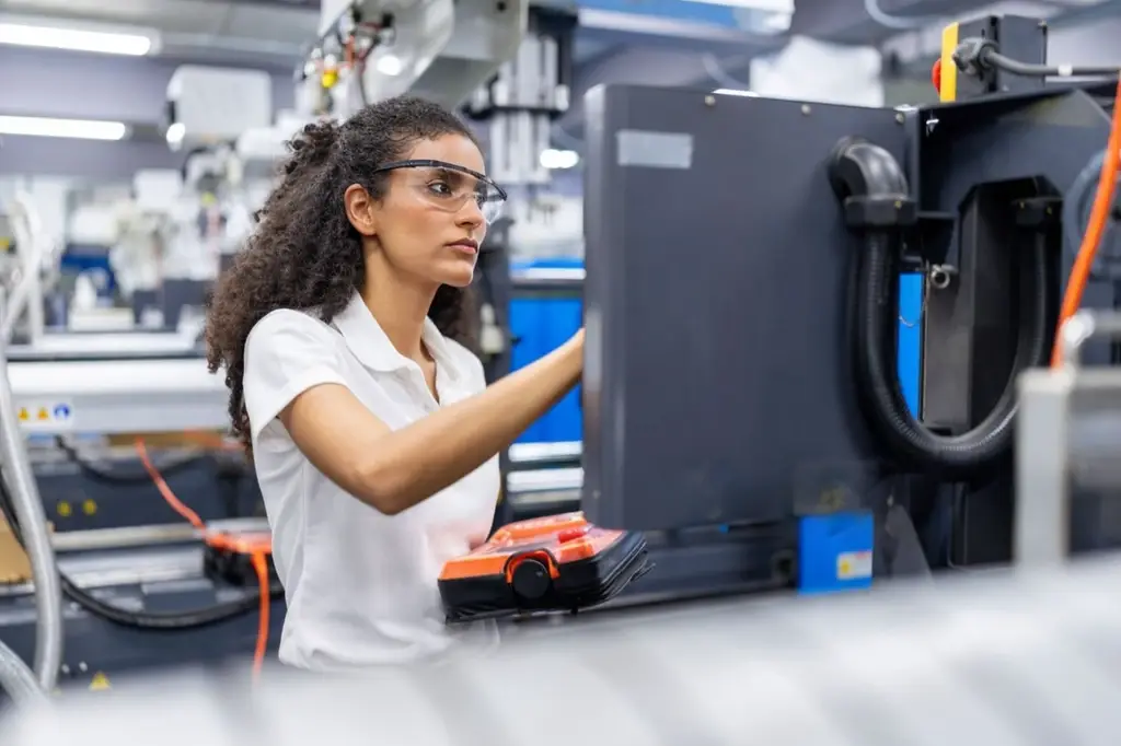 Manufacturing Engineer testing automation systems on the production floor.