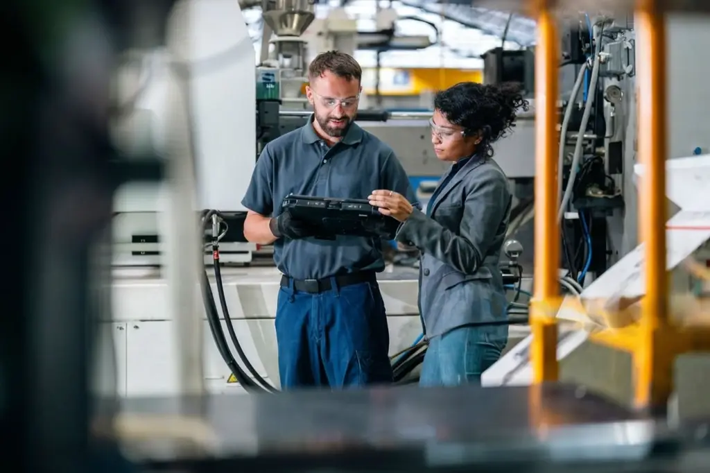 Process Engineer reviewing a CNC Production Cell.