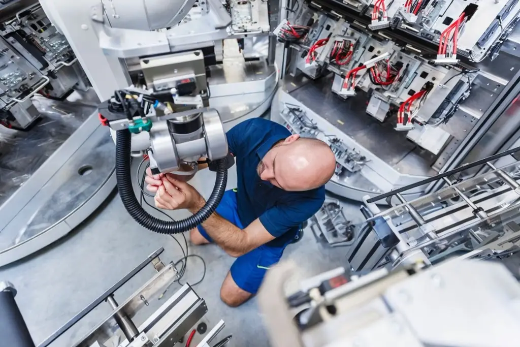 CNC Repair Technician fixing a Milling Center.