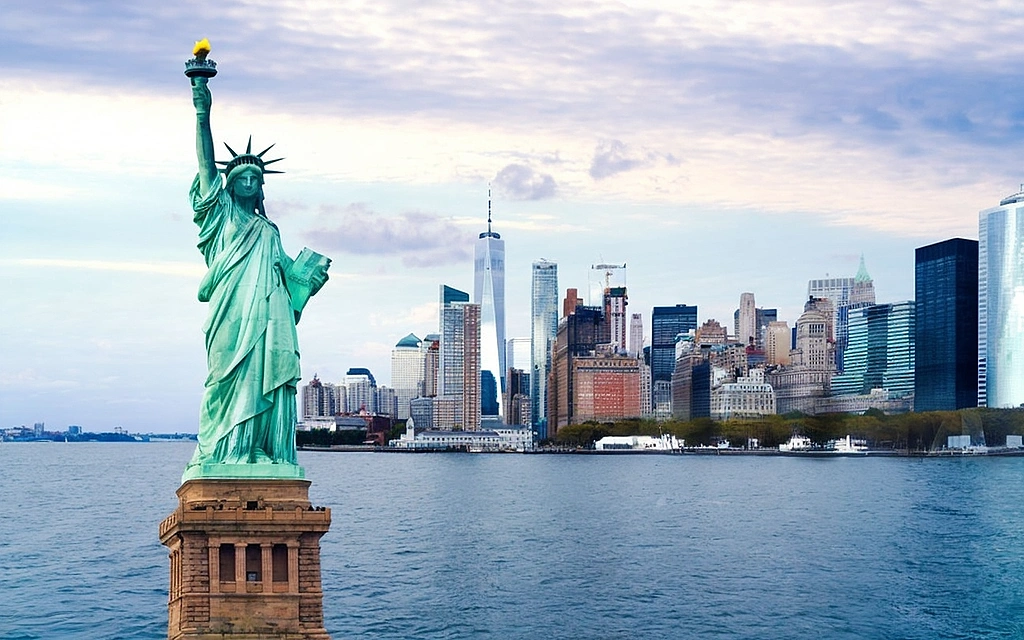 New York, NY skyline with the Statue of Liberty in the foreground.
